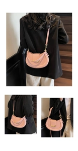 Detail of pink lychee textured leather saddle bag with elegant gold hardware accents