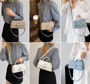 Detail showing various colors of leather handbags with silver square metal locks