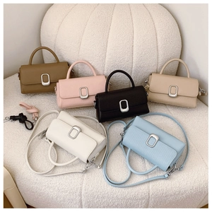 Detail view of colorful retro leather handbags with lychee texture and silver metal buckles