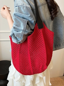 Chic red crochet tote bag with woven mesh design and wide black shoulder strap