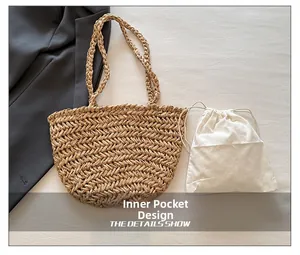 Detail showing the straw tote bag with its white canvas drawstring inner bag design