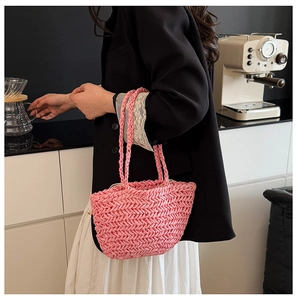 Pink straw woven basket bag with herringbone texture and dual round handles for women