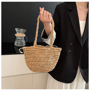 Close-up of woven straw handbag featuring dense herringbone pattern and white drawstring