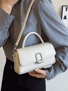 Retro minimalist off-white woven structured handbag with silver buckle and crossbody strap