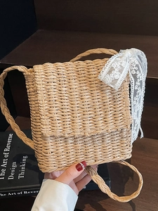Handmade beige straw woven crossbody bag with lace bow decoration for summer beach vacation