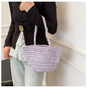 Detail shot of light purple woven straw shoulder bag with hand-knit texture