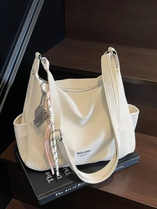 Minimalist cream white tote bag with textured synthetic leather and tennis racket charm