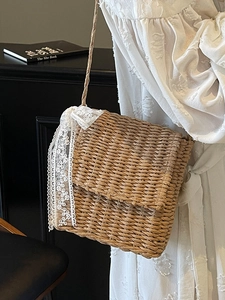 Artistic straw woven crossbody bag with white lace trim for summer beach vacation style