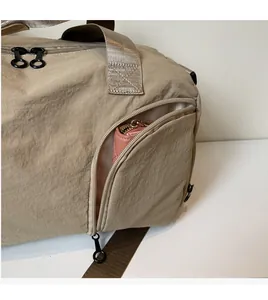 Detail view of large travel bag side zipper pocket storing a pink wallet and durable fabric