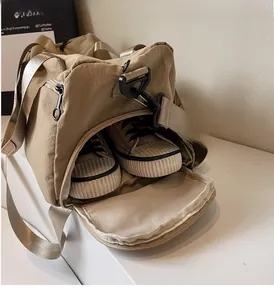 Close-up of large khaki travel bag featuring a specialized independent shoe compartment