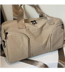 Close-up of khaki nylon travel bag showing durable fabric texture and reinforced handles