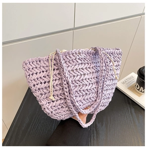 Close-up of lavender purple straw woven bag with intricate V-pattern and cream drawstring closure