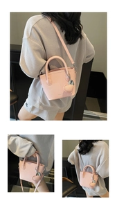 Detailed views of a pink lychee-textured bucket bag with a heart charm and strap