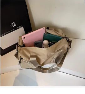 Macro view of khaki travel bag interior showing large capacity for electronics and umbrellas