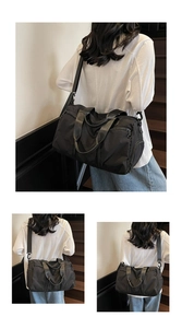 Detail view of a large black nylon sports bag with reinforced handles and adjustable strap