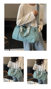 Detail of teal travel duffel bag showing waterproof nylon texture and shoulder strap