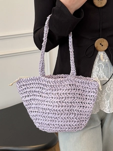 Minimalist lavender straw tote bag featuring herringbone weave and drawstring closure