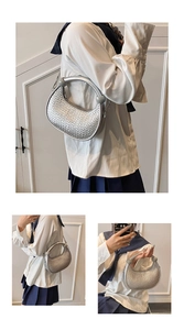Detail of silver woven hobo bag showing sturdy top handle and metal chain shoulder strap