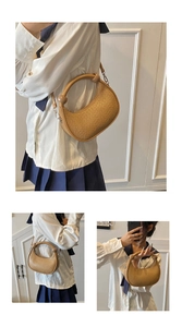 Detail of woven texture leather handbag with crescent shape and spherical handle accents