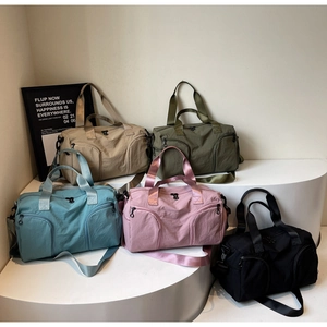 Five assorted colors of durable travel bags with shoe compartment and shoulder straps