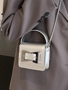 Chic silver mini square bag with metallic buckle and chain strap shown on blazer