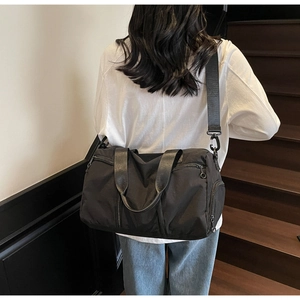 Practical black nylon travel bag with shoe compartment and adjustable shoulder strap