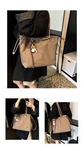 Detail of khaki drawstring tote bag featuring clover metal logo and baseball charm
