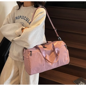 Pink large travel bag detail with side shoe compartment and adjustable shoulder strap