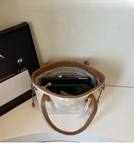 Top view of large white marble pattern tote bag showing spacious interior with tablet and phone
