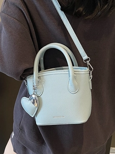 Chic light blue lychee pattern bucket bag with heart pendant and adjustable strap