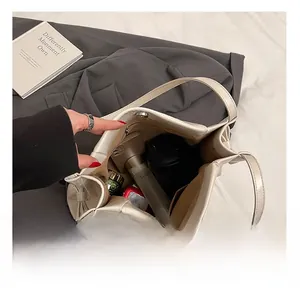 Detailed interior of the soft leather tote bag showing spacious storage with zipper pockets
