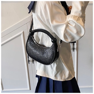Close-up of black woven hobo bag showing faux leather texture and silver hardware