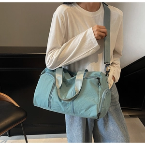 Macro shot of light blue travel bag with reinforced straps and spacious compartments