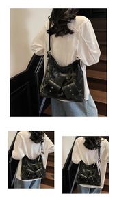 Detail of marble texture tote bag with pearl chain and leather buckle accents