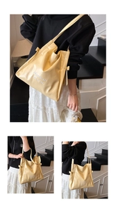Detail of cream yellow tote bag showing soft glossy leather and bow embroidery