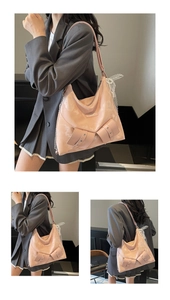 Detail of pink hobo bag with large bows, pearl chains and lace shoulder strap