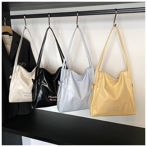 Row of colorful soft PU leather tote bags in four colors with embroidered bow detail