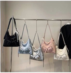 Detailed display of fashionable tote bags in multiple colors with metallic chain straps