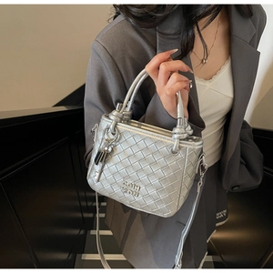 Detail of silver woven bucket bag with metallic finish and COIH 2DN embossed logo