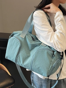 Light blue waterproof travel bag for sports and fitness with shoe compartment and strap