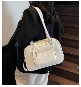 Close-up of stylish white shoulder bag with embossed Noronoro logo and zipper detail