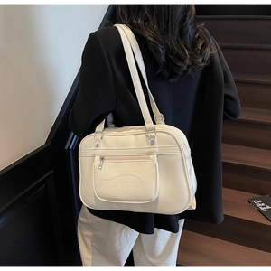 Detail showing the cream white faux leather texture and Noronoro embossed logo on the bag