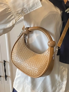 Chic light brown woven dumpling bag with rounded handle and detachable shoulder strap