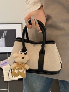 Canvas and black leather contrast bucket bag with teddy bear charm for women