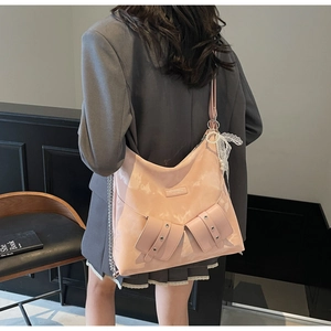 Detail of pink PU leather tote with butterfly bows and stylish pearl charm