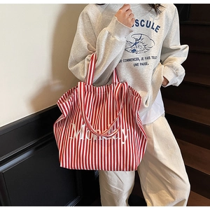 Close-up of red and white striped canvas tote bag featuring Monday print detail