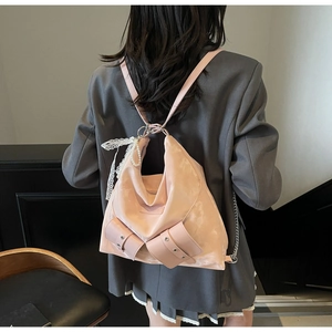 Pink ribbon backpack with bow and pearl detail shown on a grey blazer outfit back view