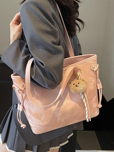 Pink faux leather tote bag with cloud texture and brown plush bear charm for women