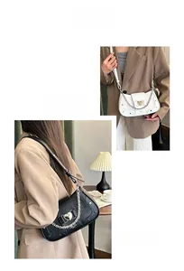 Detail of stone pattern shoulder bag with heart-shaped metal lock and chain