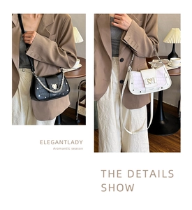 Detail of stone pattern shoulder bag featuring golden heart buckle and chain strap